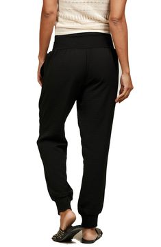 A wide waistband and notched cuffs provide a comfy fit in relaxed joggers featuring convenient side pockets. 28" inseam; 8" leg opening; 10 1/2" front rise; 14 1/2" back rise (size S) 100% polyester Dry clean Made in the USA Black Jogging Pants With Elastic Cuffs, Black Activewear With Comfort Waistband And Tapered Leg, Black Activewear With Ribbed Waistband And Tapered Leg, Black Tapered Leg Activewear With Comfort Waistband, Black Tapered Leg Activewear With Ribbed Waistband, Sporty Joggers With Cuffed Ankles, Athleisure Pants With Elastic Cuffs, Athleisure Ankle-length Sweatpants With Elastic Cuffs, Relaxed Fit Athleisure Bottoms With Cuffed Ankles