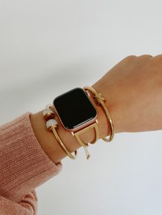 Elevate your Apple Watch bans with our stunning wrist stack featuring a luxurious gold stainless steel Apple Watch band, a chic screw lock bracelet for a touch of edge, and a dazzling gold CZ cuff that adds a hint of glamour. Elevate your everyday style with this curated combination, blending modern sophistication with timeless elegance. Perfect for expressing your unique personality, this wrist stack effortlessly combines functionality with fashion, ensuring you stand out in every moment. Apple Bands For Women, Fancy Apple Watch Bands, Apple Watch Stacked With Bracelets, Elegant Gold Apple Watch Band, Adjustable Gold Apple Watch Band For Everyday, Apple Watch Jewelry Stack, Apple Watch With Bracelets, Apple Watch Stack, Apple Watch Bracelet Stack