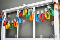 colorful paper streamers hanging from the side of a window