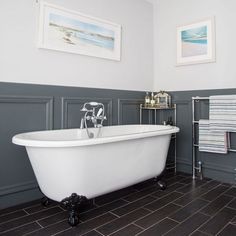 a white bath tub sitting in a bathroom next to a radiator