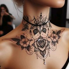 a woman's neck with flowers and leaves on it