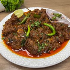 a white plate topped with meat and vegetables