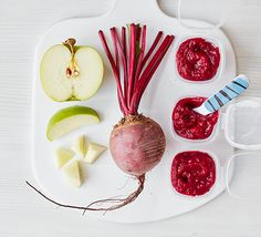 an assortment of fruits and vegetables are arranged on a white platter with sauces