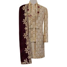 Upgrade your wedding ceremony look with this highly-priced golden sherwani for grooms. Crafted from splendid silk, it capabilities problematic elaborations and conventional motifs that exude elegance. The tailored suit and complicated mandarin collar enhance your silhouette, even as the contrasting deep burgundy dupatta provides a hanging touch. Features Color and Fabric: The sherwani is a rich golden hue, exuding beauty and opulence. The fabric is possibly a extremely good silk amd brocade, inc Luxury Gold Embroidered Sets For Ceremony, Designer Luxury Embellished Sherwani, Gold Bandhgala With Gota Work For Festive, Gold Traditional Wear For Reception, Gold Bandhgala With Gota Work For Festive Occasions, Festive Gold Bandhgala With Gota Work, Traditional Wedding Sherwani With Gota Work, Festive Gold Sherwani With Gota Work, Gold Sherwani With Dupatta For Reception