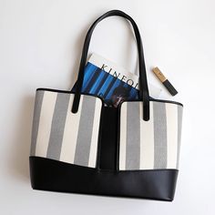 Wherever life may take you, this tote ensures you can bring all the essentials. The large tote is cut from leather to an unstructured, boxy silhouette with contrast stripes at front. Stylishly oversized, its chic design and bold stripes speak of balmy weather and days by the sea, but it’s sturdy and chic enough to transport your office must-haves, too.Weight: 300 gWidth (cm): 12 cmHeight (cm): 26 Color: White, Black, GrayInterior Material: Polyester CottonMaterial_bag: Two-Layer CowhideBagType: Coated Canvas Box Bag For Shopping, Modern Coated Canvas Satchel Tote, Shopping Shoulder Bag With Double Handles And Card Slots, Modern Large Capacity Tote Box Bag, Chic Coated Canvas Bucket Bag For Shopping, Rectangular Coated Canvas Shoulder Bag With Interior Card Slots, Chic Bags With Interior Card Slots For Daily Use, Rectangular Box Bag With Interior Card Slots For Shopping, Square Coated Canvas Shoulder Bag With Large Capacity