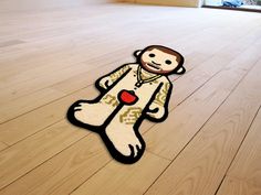 a floor mat with a cartoon monkey holding an apple on it's back legs