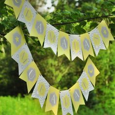 a yellow and silver banner hanging from a tree