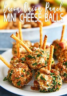 mini cheese balls on a white plate with parmesan bread sticks in the middle