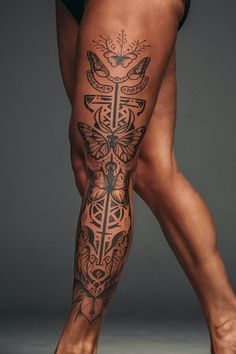 a woman's legs with tattoos on them