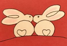 two white rabbits sitting on top of each other with hearts in their ears and eyes