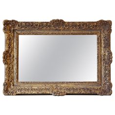 an ornate gold framed mirror against a white background