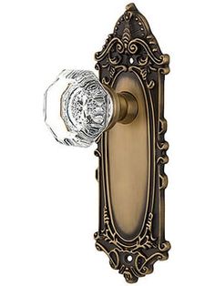 an antique style door handle with glass knob