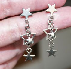 Stainless steel star charm and star stud earrings. Earring length: 40mm  Earring stud material: 316 stainless steel Charm material: zinc alloy Backs: rubber This listing is for 1 pair of star charm dangle earrings.  These earrings will come in a gift bag. I offer combined shipping costs which give you a shipping discount for ordering multiple items from my shop. Please note: this item will be sent for free via standard unregistered post, without tracking number.  If you would like to be registered upon check out you can choose to upgrade to registered post. See more chain/cord/wire click here: http://etsy.me/2qSGJ6b Don't forget to purchase the matching set of bails, clasps, necklace/bracelet connectors click here:  http://etsy.me/2re5rjD ...and check out some of charms & pendants listings Nickel-free Metal Star Earrings, Nickel-free Star Shaped Metal Earrings, Nickel-free Star-shaped Metal Earrings, Hypoallergenic Star-shaped Metal Earrings, Silver Star Charm Earrings In Stainless Steel, Silver Stainless Steel Star Charm Earrings, Silver Stainless Steel Earrings With Star Charm, Bracelet Connectors, Star Stud Earrings