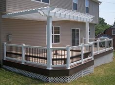 a house with a deck and pergolated patio