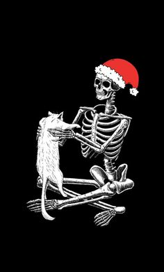 a skeleton sitting on the ground with a cat in it's lap wearing a santa hat