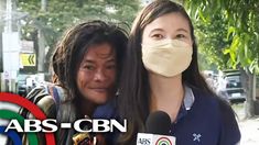 a woman with a face mask is being interviewed by a news reporter