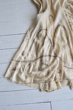 "Antique 1920s cream silk charmeuse dress with cream lace filled cutouts outlined with pearls, classic 1920s simple shape and drop waist and side metal hook and eye closures. [m e a s u r e m e n t s] fits like: extra small/small bust: best fit up to 32.5\" waist: best fit up to 26\" hip: free length: 42\" [i n f o] brand/maker: n/a fabric content: silk condition: excellent (very faint underarm discoloration), and a break in the lace on the skirt, see close up. to ensure a good fit, please read 1920s Cream Summer Dress, 1920s Style Cream Summer Dress, Cream 1920s Style Summer Dress, Ivory Slip Dress, Wedding Dress Silk, 20s Dress, 1920s Wedding Dress, Silk Charmeuse Dress, Charmeuse Dress