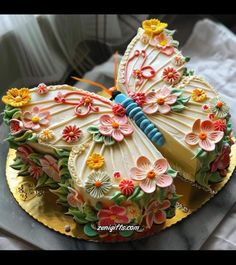 a cake decorated with flowers and a butterfly