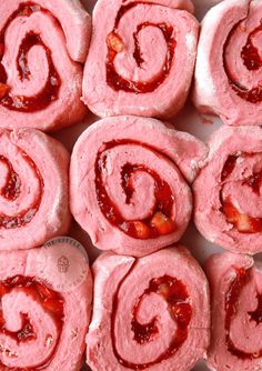 several pink rolls with strawberry jam on them