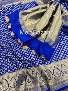 Dazzling royal blue Katan silk blend Banarsi saree. Dense gold  zari butas and tassels on the palla! Blouse fabric included. Fall attached. Note: The color of the products may slightly vary according to the lighting conditions and the color calibration of the viewing LED devices. If you would like more clarity before your purchase, please drop us a message . Banarasi Silk Blouse Piece With Latkans For Eid, Blue Tissue Silk Traditional Wear For Eid, Blue Tissue Silk Traditional Wear For Festive Occasions, Royal Blue Art Silk Saree For Festive Occasions, Royal Blue Saree For Diwali, Festive Royal Blue Saree, Royal Blue Banarasi Silk Saree With Zari Work, Art Silk Saree With Latkans For Festivals, Royal Blue Saree With Pallu For Diwali