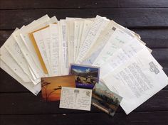 a pile of papers sitting on top of a wooden table