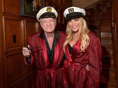 a man and woman in red robes posing for the camera