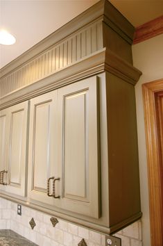 an image of a kitchen setting with white cabinets