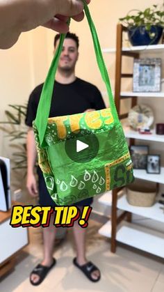 a person holding a green bag with the words best tip on it in front of them