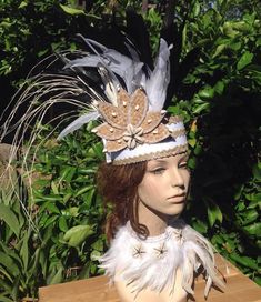 "This is a sample of what we can make for you. Neck piece is not included. All Costumes are made to order! OPTION-- You can also change the feathers to your own color except white feathers. change the band color to any color you like. NOTE- please message us if you like to change to all white feathers, white feathers will cost you a lot more, so message us so we can discuss the price. :) MEASUREMENT Headpiece height is 3\" tall. Feathers measures- 8\"- 10\" long/length. 7\" flower. LISTING ONE H Bohemian Adjustable Tall Crown Headpiece, Adjustable Bohemian Tall Crown Headpiece, Handmade White Wedding Costume Hats And Headpieces, White Handmade Wedding Costume Hats And Headpieces, Bohemian Handmade Tall Crown Headpiece, Handmade Bohemian Tall Crown Headpiece, Handmade Bohemian Headpiece With Tall Crown, Handmade White Wedding Headpieces, Ceremonial Headpiece With Tall Crown