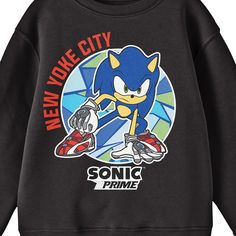 Celebrate your favorite animated series in comfort with this Sonic Prime sweatshirt. The shirt features an image of Sonic crouching in a font of a circle filled with geometric shapes while red letters read, "New Yoke City." Black letters below the image spell out the series logo. Fans of the Sonic Prime animated series will love this comfy and cozy sweatshirt. Black Crew Neck Sweatshirt With Character Print, Pop Culture Sweatshirt With Letter Print For Fans, Pop Culture Letter Print Sweatshirt For Fans, Pop Culture Letter Print Sweatshirt Fan Merchandise, Black Pop Culture Crew Neck Sweatshirt, Cotton Fandom Sweatshirt With Graphic Print, Cotton Fandom Graphic Sweatshirt, Character Print Long Sleeve Sweatshirt For Fans, Cotton Graphic Print Fandom Sweatshirt