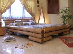 a large bed sitting in the middle of a living room