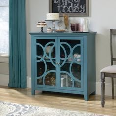 a blue cabinet with glass doors in a living room