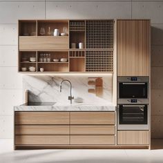 a modern kitchen with marble counter tops and wooden cabinetry, along with built - in appliances