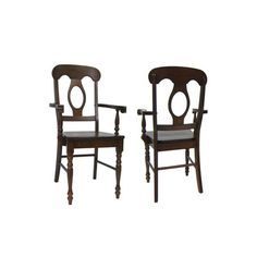 two wooden chairs sitting next to each other