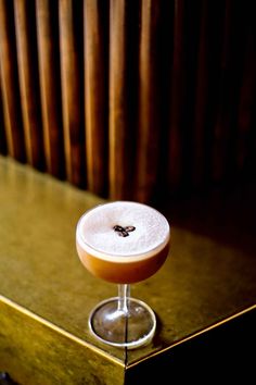 a drink sitting on top of a wooden table