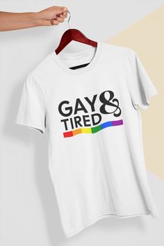 "Introducing our fabulous \"Gay And Tired\" T-Shirt, a prideful and empowering garment that celebrates the LGBTQIA+ community. This shirt is designed for those who proudly identify as LGBTQIA+ and embrace their uniqueness with a touch of humor. Crafted with love and inclusivity, this Pride Shirt is a bold statement piece that showcases the powerful message of being \"Gay And Tired.\" It is a symbol of resilience, strength, and pride in the face of adversity. Wear it with pride and let the world Sarcastic Shirts Funny, Pride Parade, Pride Rainbow, Slogan Tee, Sarcastic Shirts, Yoga Tank Tops, The Pride, Pride Shirts, Yoga Women