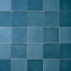 a blue tiled wall with no one in it