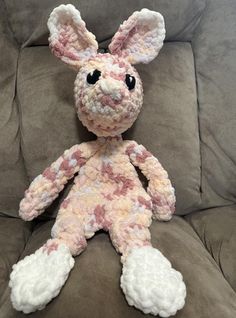 a crocheted bunny sitting on top of a couch