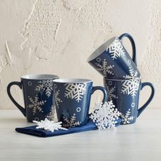 three blue cups with white snowflakes on them