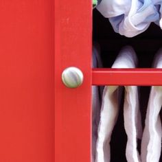 an open red door with white socks in it