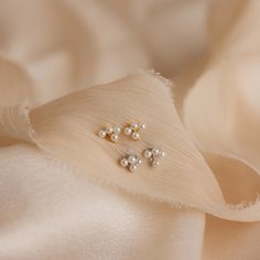 Our Pearl Cluster Drop Studs are the perfect wedding accessory for brides who adore a blend of elegance and ease. Whether you're walking down the aisle or dancing the night away, these earrings add a touch of timeless charm to any wedding look, ensuring you feel extra beautiful on your special day ♡ SKU: RR-ER497 Product Details Material: High Quality Solid 925 Sterling Silver Finish: 18K Gold ∙ Sterling Silver Featuring ~6x6.5mm Stud Earrings with a ~3x6.5mm Trio Pearl Bar and ~3.5x2mm Pearl Da White Dainty Bridal Earrings For Formal Occasions, Formal White Dainty Bridal Earrings, Dainty Sterling Silver Ear Climbers For Wedding, Delicate Sterling Silver Bridal Earrings For Party, Delicate Pearl White Bridal Earrings For Party, Delicate Evening Pearl Earrings For Pierced Ears, Sterling Silver Ear Climbers For Wedding, Delicate Pearl Earrings For Evening, Elegant Ear Climbers For Anniversary