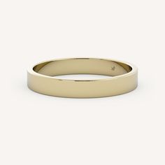 a plain gold wedding ring on a white background