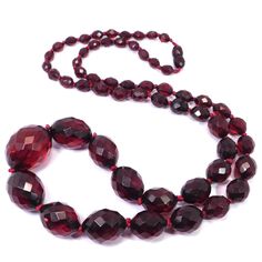 Deep red faceted beads graduated in size hand knotted on red string with a hidden clasp.  The largest bead measures 1 and ⅛ inch long by ⅞ inch wide.  The necklace is 32 inches long and weighs 57 grams.  Tested and guaranteed bakelite from an estate in San Francisco which included a large collection of vintage bakelite.  Very good condition, no damaged beads and the string is still strong so this beauty is ready to wear. Formal Red Faceted Necklace, Classic Red Faceted Necklaces, Red Round Beads For Formal Occasions, Classic Red Hand-strung Necklaces, Classic Red Single Strand Beaded Necklace, Formal Red Round Beads, Classic Red Single Strand Necklace, Formal Red Beaded Necklaces With Polished Beads, Formal Red Beaded Necklace With Polished Beads