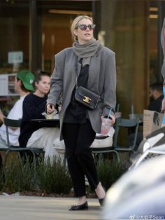 a woman walking down the street with her purse