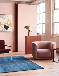 a living room with pink walls and furniture