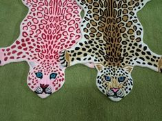 two animal rugs with different designs on them