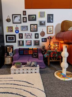 a living room filled with furniture and pictures on the wall