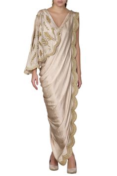 Gold saree dress with placement leaf work and scallop border.
Components:1
Bead and sequin embroidery
Neckline:V-shaped neckline
Sleeve Length:Sleeveless
Fabric:Satin
Color:Gold
One shoulder  drape
Deep v-shaped back - Aza Fashions Drape Saree Indo Western, Draped Saree Gown, Gowns Gold, Panelled Dress, Saree Gowns, Drape Sarees, Draping Fashion, Gown For Women, Saree Gown