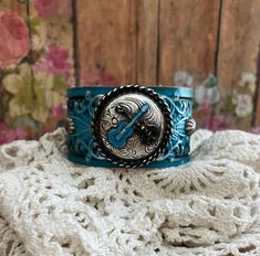 v'¯) .`*.¸.*' ★ LOve LoVe LovE this one! ★ ¸.*'.*'¨) ¸. (¸.*'(¸.*' (¸. This DESIGN ~ ❤ Silver double guitar concho was brought to life with deep turquoise and black patina. ❤ Silver filigree inked with turquoise. ❤ Handpainted tooled leather in turquoise, washed in black, distressed and sealed. ❤ Width of leather is approximately 1 1/2 inches. BRACELET SIZING INFO: My women's bracelets are approximately 8 1/2 inches end to end. I place 2 snaps at 7 and 7 3/4 inches for adjustability. Jewelry for Adjustable Western Cuff Bracelet For Festivals, Adjustable Western Style Cuff Bracelet For Festivals, Adjustable Western Style Festival Cuff Bracelet, Western Style Adjustable Cuff Bracelet For Festivals, Adjustable Concho Cuff Bracelet For Festival, Adjustable Music-themed Bracelets For Concerts, Double Guitar, Guitar Bracelet, Guitar Jewelry