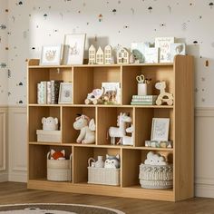 a child's bookcase with toys and pictures on it in a children's room